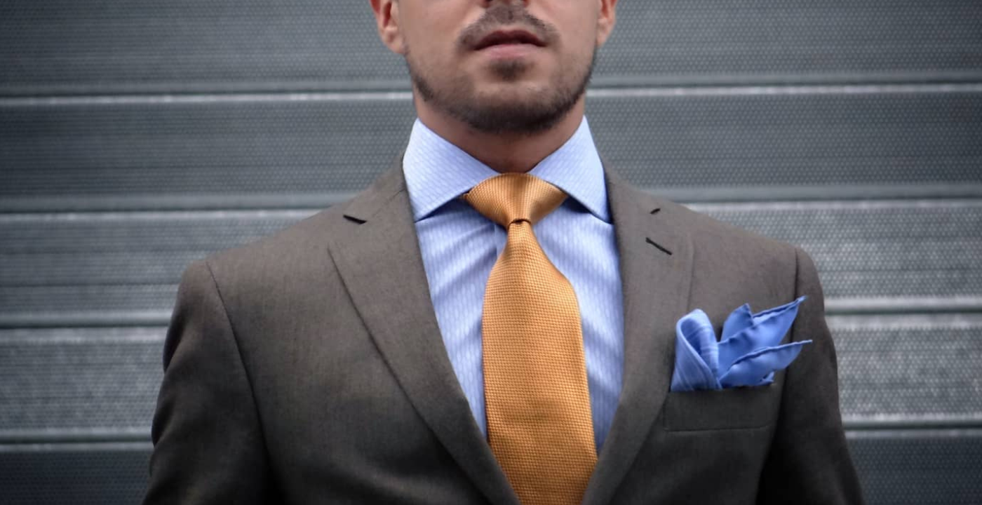 men wearing brown suit golden tie